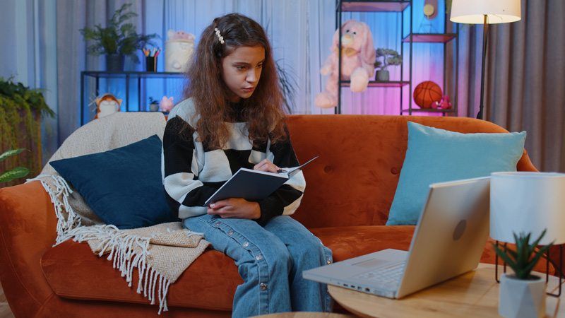 A desk with a computer set up in a teenagers room that represents the ease of access Online Therapy for Teens in Arlington. MA.
