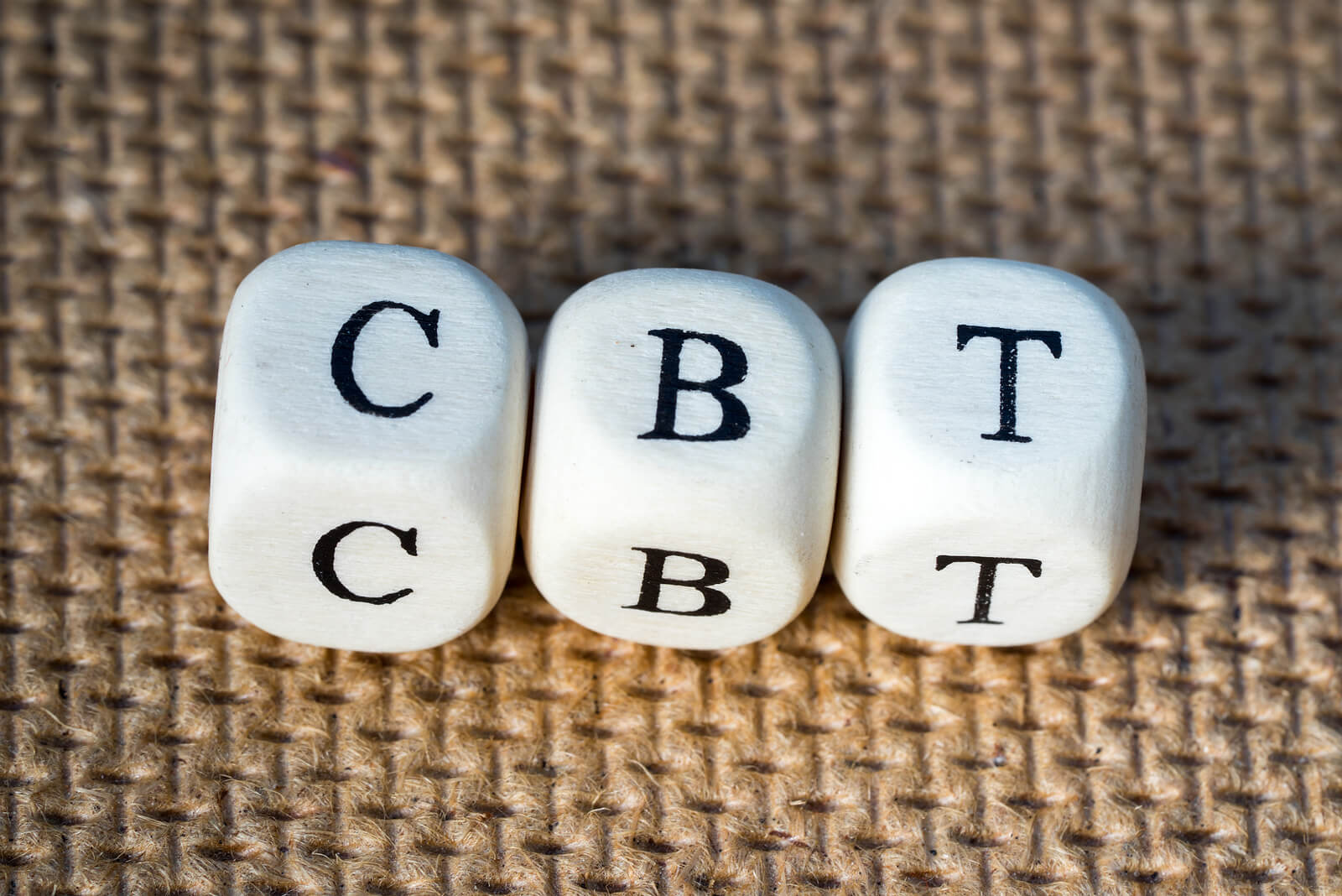 A close up of dice with letters that spell CBT. Learn how CBT can be a helpful therapy for ADHD in Arlington, MA. Search for CBT for autism or contact a child therapist in Arlington, MA to learn more about treatment for Arlington, MA today.