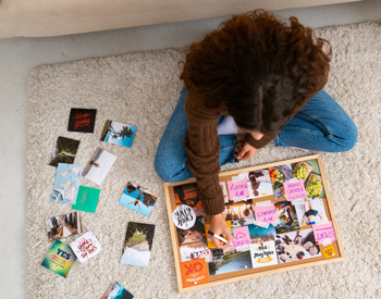 Overhead view of teenage girl making a time management board. This could represent the concept of time management that therapy for ADHD in Arlington, MA can help individuals improve. Learn more about ADHD in Arlington, MA by contacting a child therapist in Arlington, MA today. Search for CBT for autism to learn more.