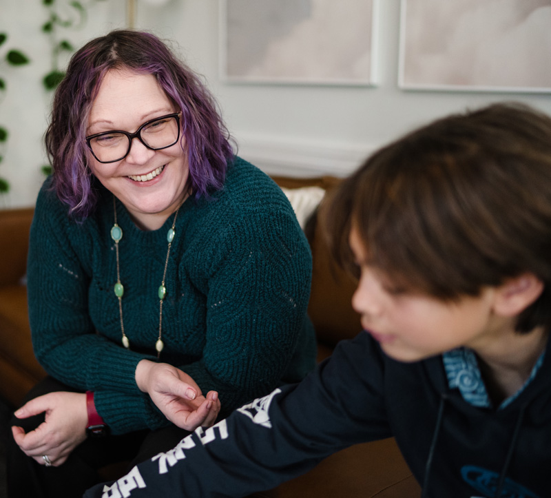 Kelly Petravicz, Social Worker at at Bain Health & Wellness Center sits with a preteen in a session