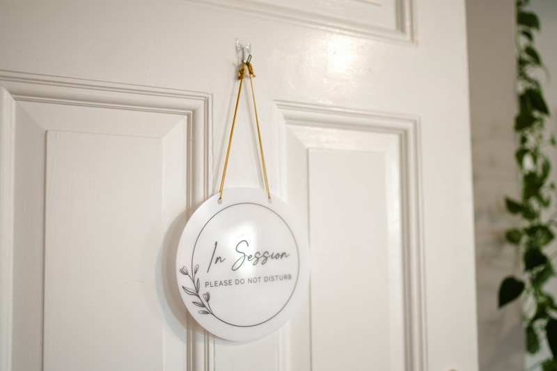 Door holding an In Session sign at Bain Health & Wellness Center