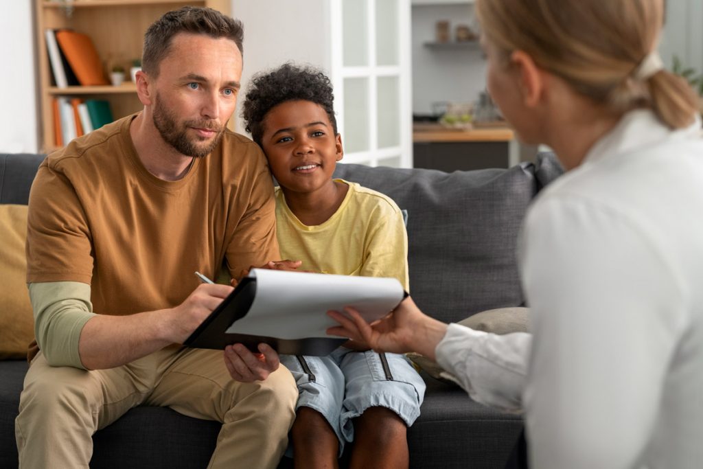 a new father signs the adoption papers for his son