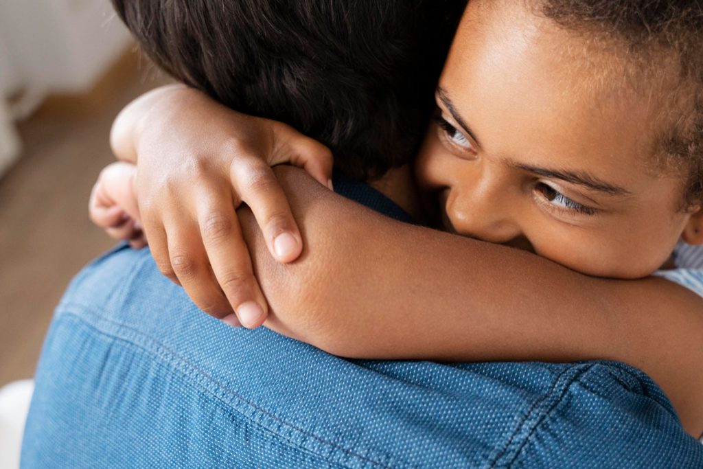 a father hugs his daughter
